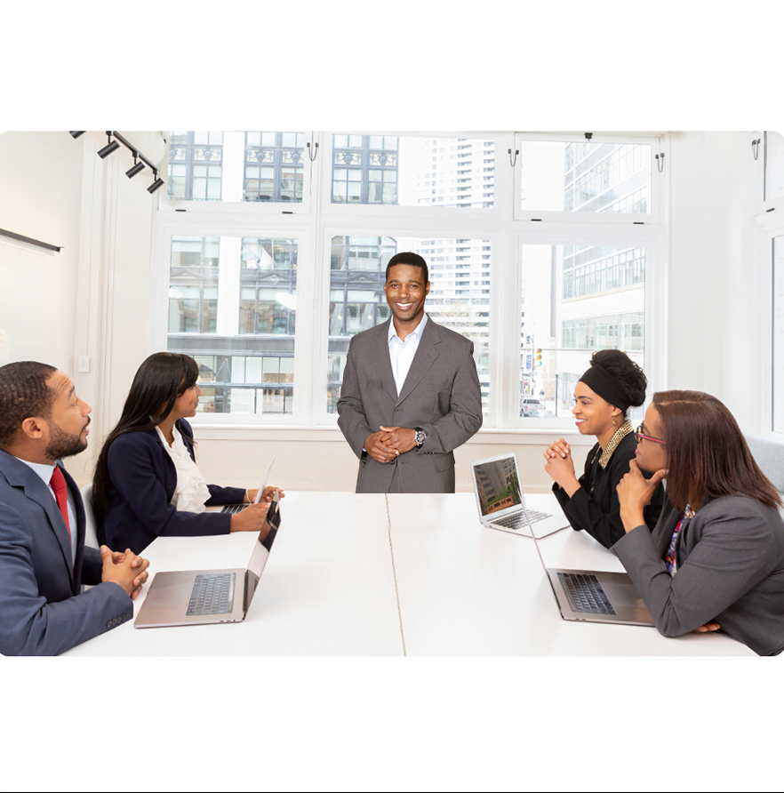 Roy D London in boardroom with staff.